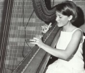 Alice plays the harp